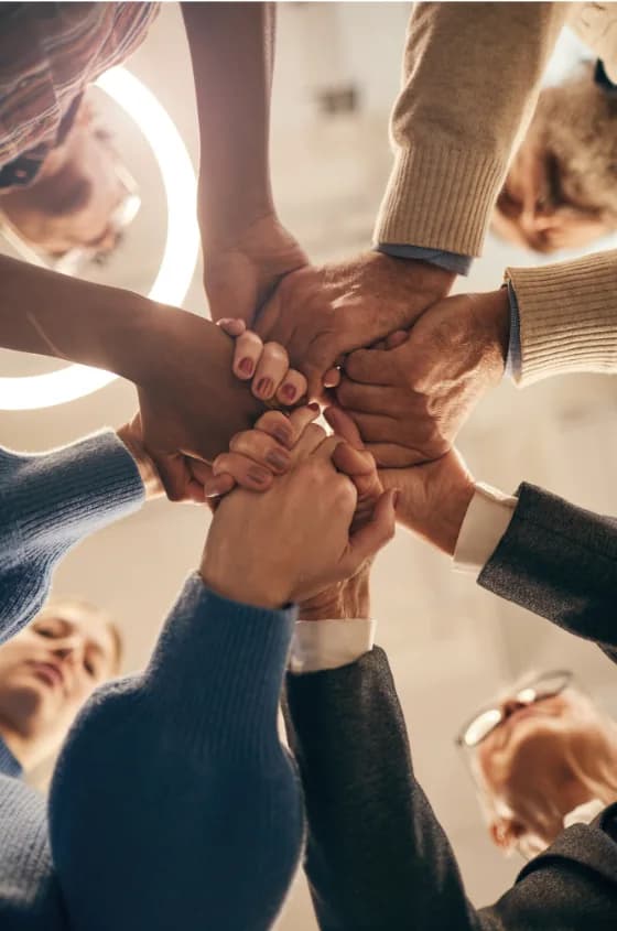 Mains d’une équipe réunies au centre en signe de cohésion